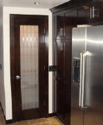 Etched glass door with grid pattern used as a kitchen pantry door.